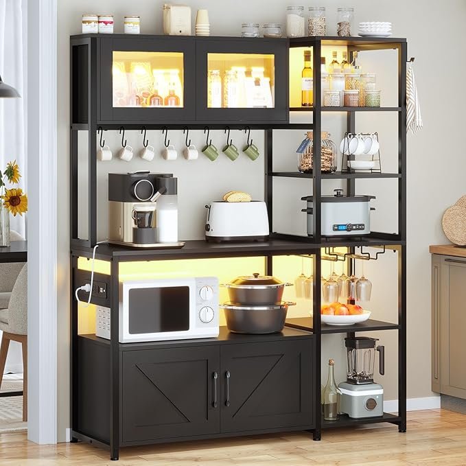 71hogQatIOL._AC_SX679_ Bakers Rack with Power Outlet and LED Light, 45.3 Inch Farmhouse Coffee Bar Cabinet, Kitchen Microwave Stand with Storage, Glass Cabinet, Goblet Holder and 8 Hooks, Black - Image 1